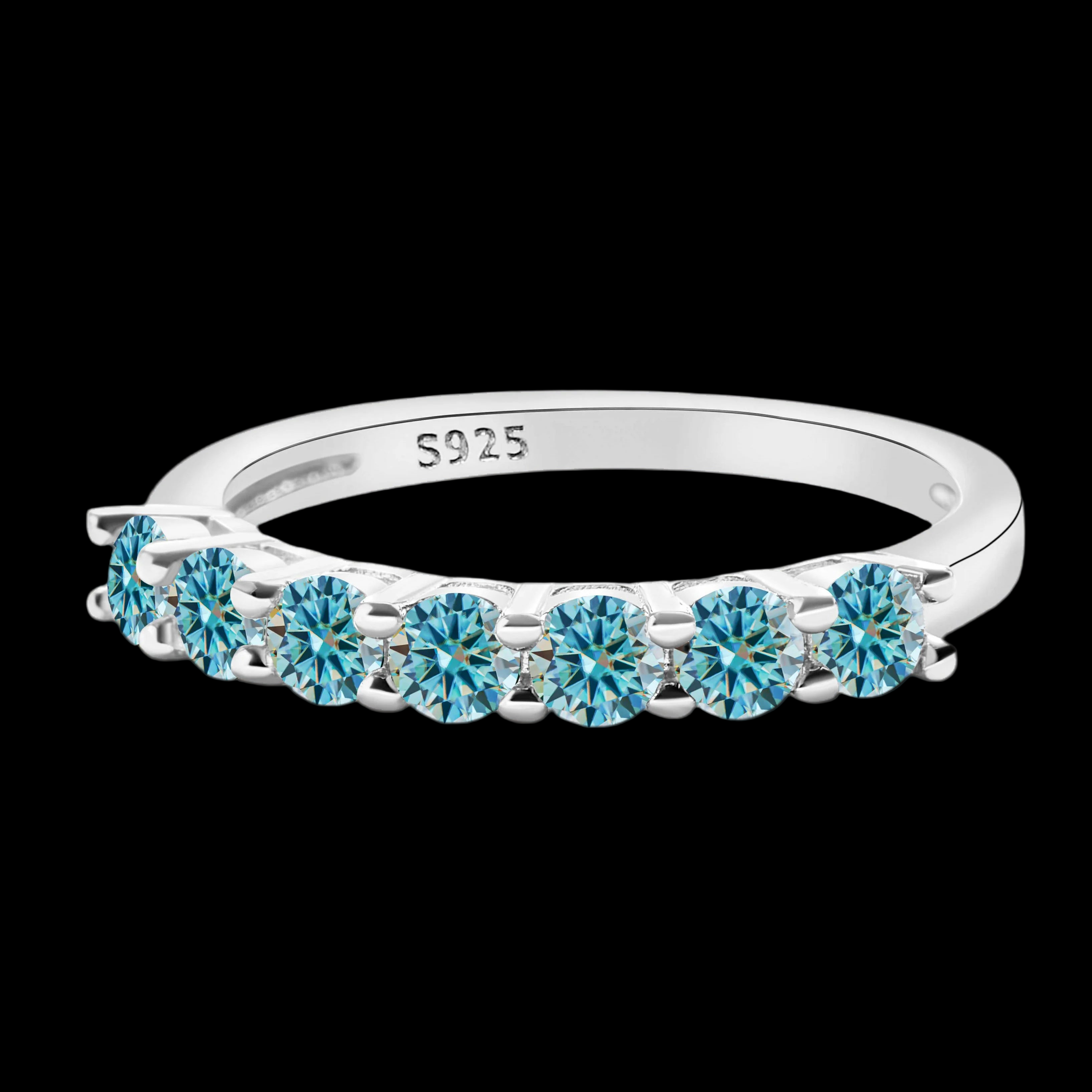 Silver ring with blue gemstones on a black background