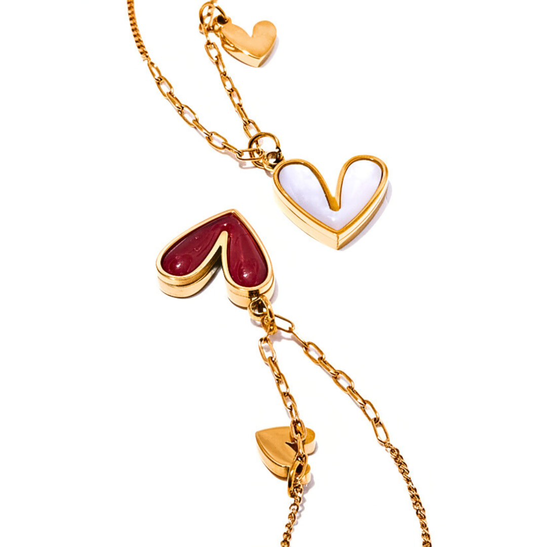 Gold necklace with heart-shaped pendants on a white background