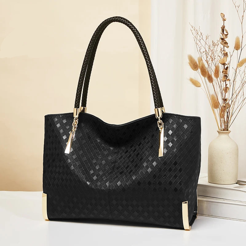 Black handbag with gold accents on a light background, featuring the FOXER brand.