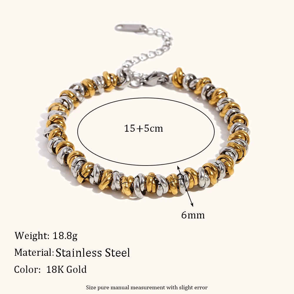 Bracelet with gold and silver beads on a white background, showing measurements and material details.