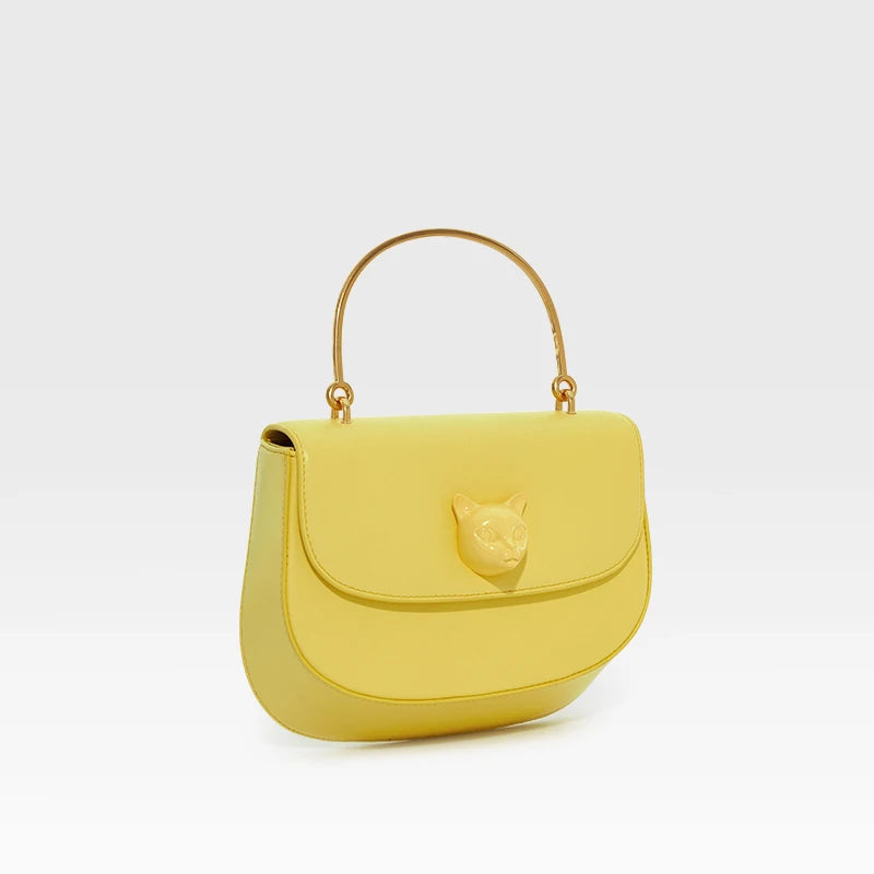 Yellow handbag with gold handle on a white background, featuring the brand 'Bafelli'.