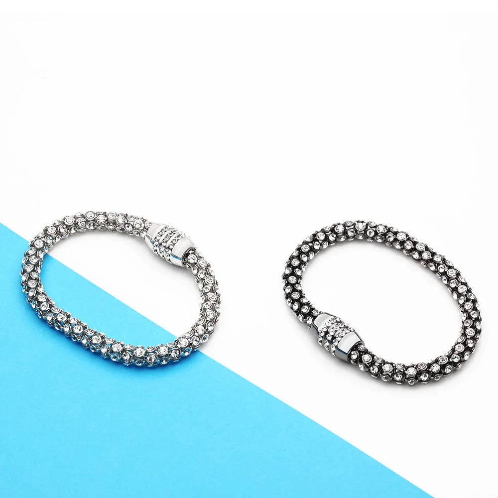 Two silver bracelets on a blue and white background with Varole branding.