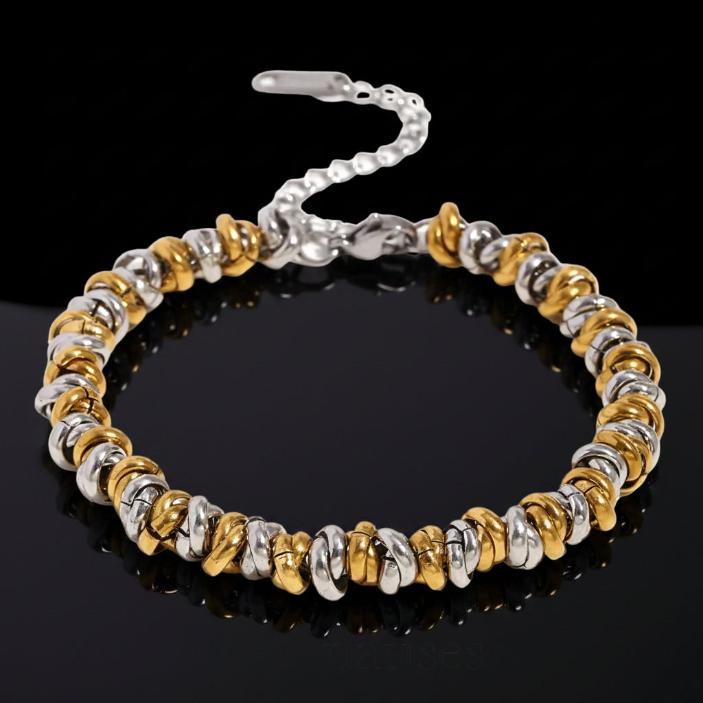 Bracelet with gold and silver beads on a white background, branded 'La Muses'.