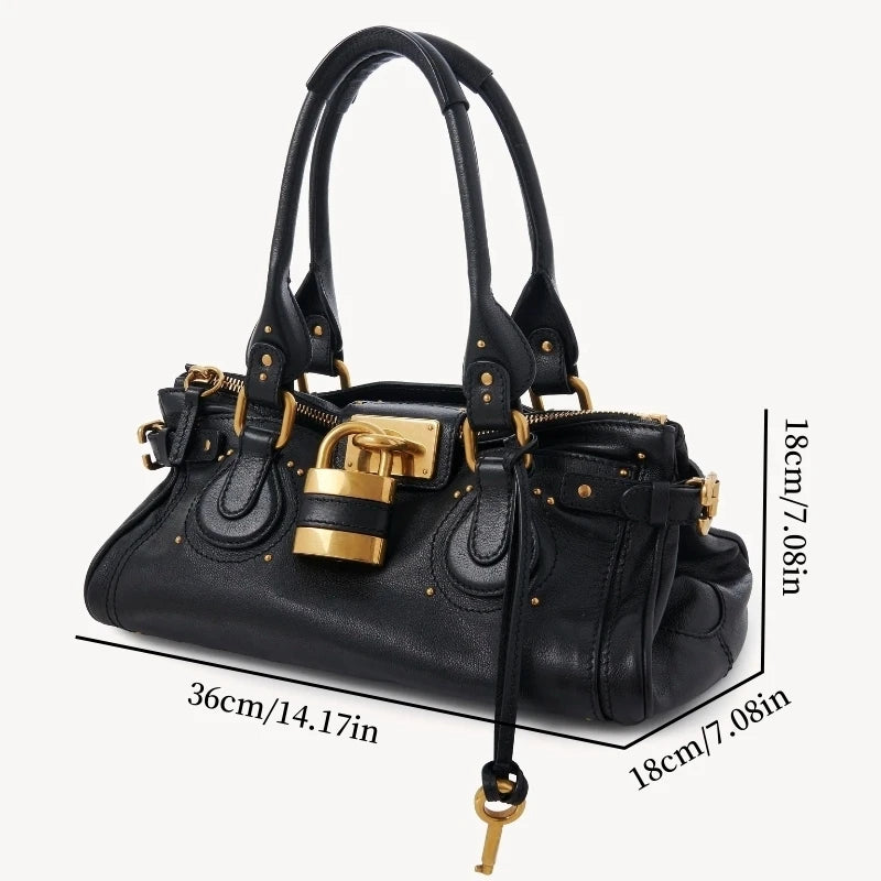 Black handbag with gold accents and measurements on a white background
