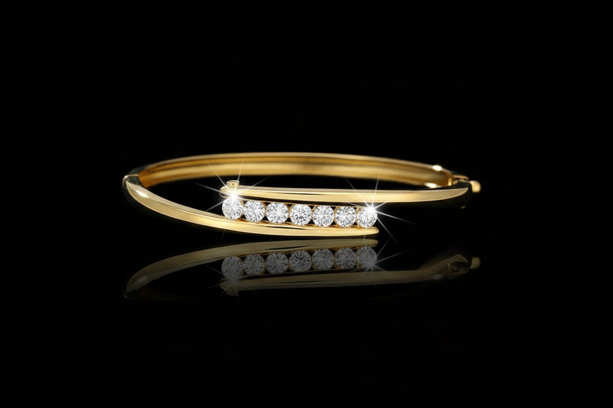 Gold bangle with embedded crystals on a black background