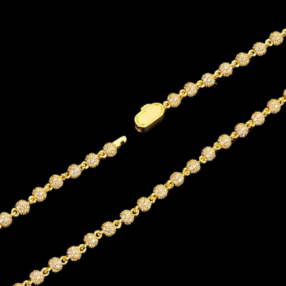 Gold bracelet with diamond-like stones on a black background