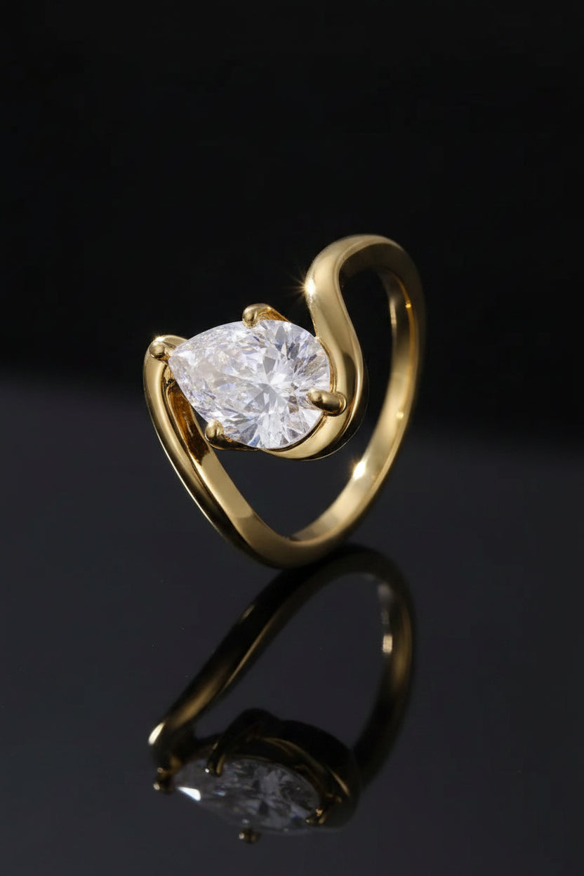 Gold ring with a heart-shaped diamond on a gray background
