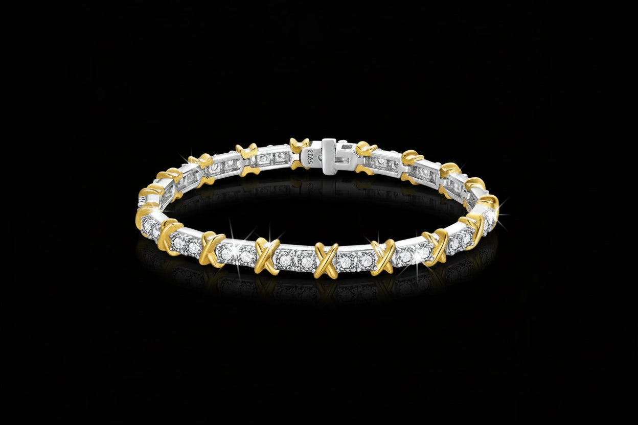 Two-tone gold and silver bracelet with diamond accents on a black background