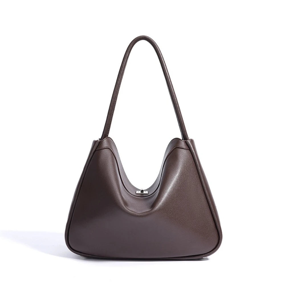 Brown handbag with a visible brand name on a white background