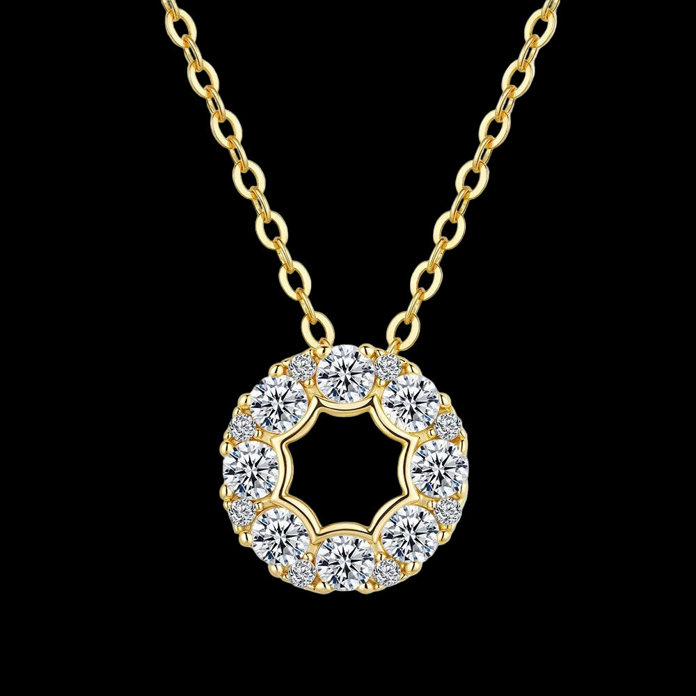 Gold necklace with a circular diamond pendant on a white background